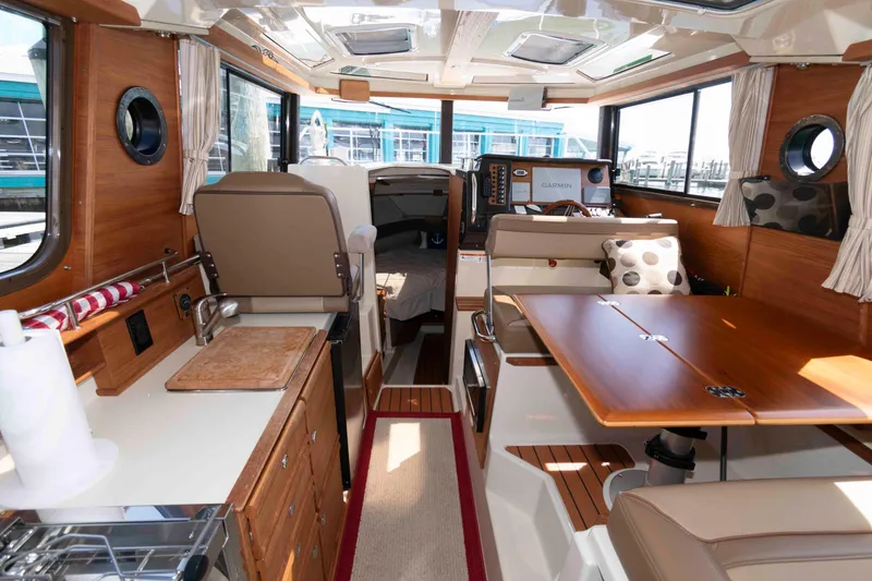 Slide: The Image of Interior of 2020 Ranger Tugs R-27 boat, featuring wood finishes and modern amenities. - 5