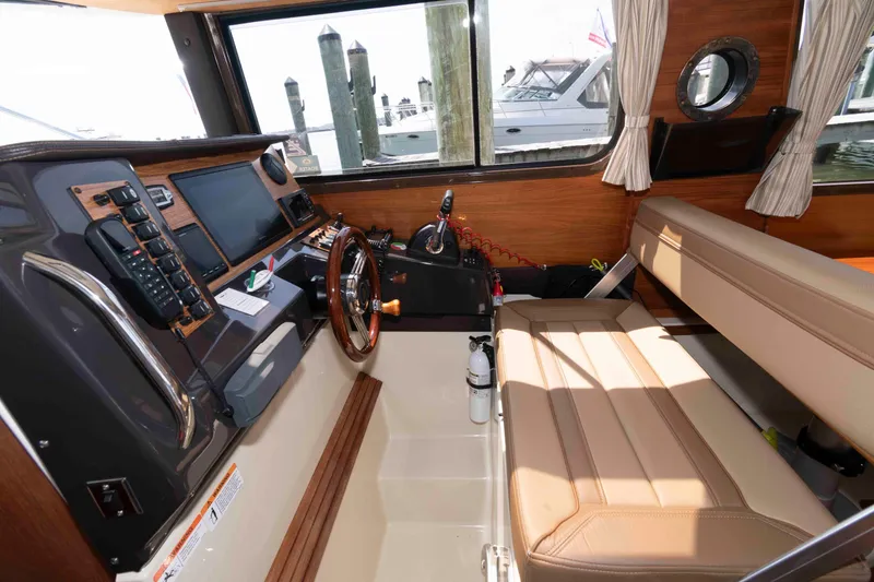 Slide: The Image of Interior of 2020 Ranger Tugs R-27 boat with steering wheel and navigation equipment. - 8