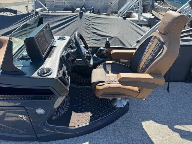 Slide: The Image of Interior of 2026 Bennington 23MSB with luxurious captain's chair and helm console. - 17