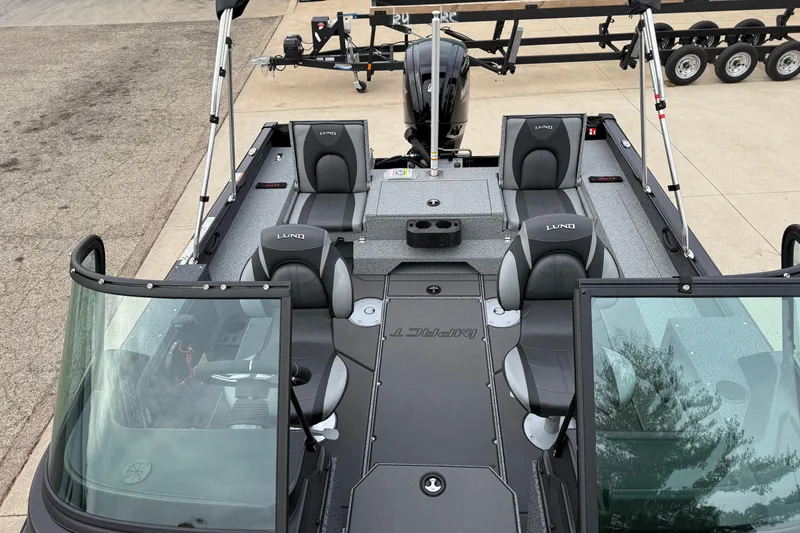 Slide: The Image of 2026 Lund 1775 Impact XS Sport boat interior with seating and steering wheel. - 13