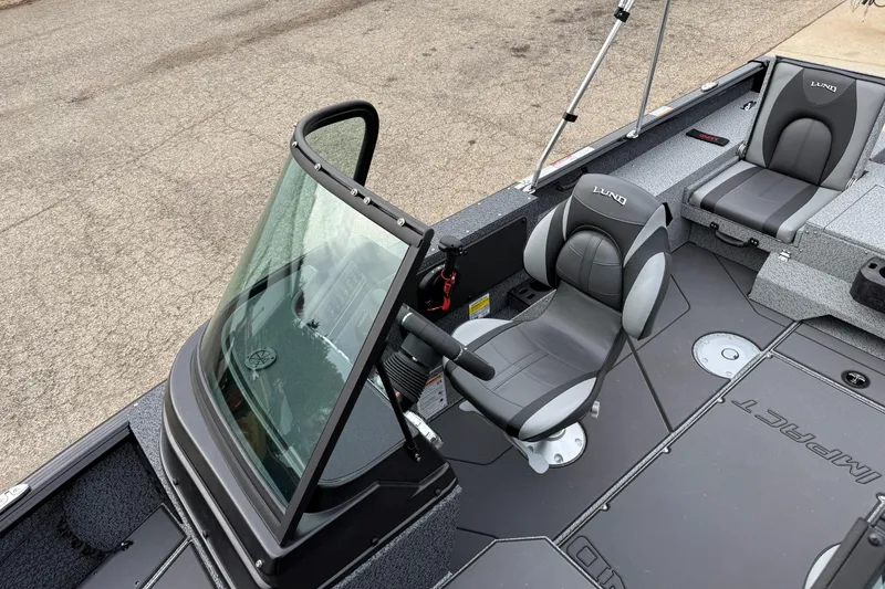 Slide: The Image of 2026 Lund 1775 Impact XS Sport boat interior with seating and console. - 14