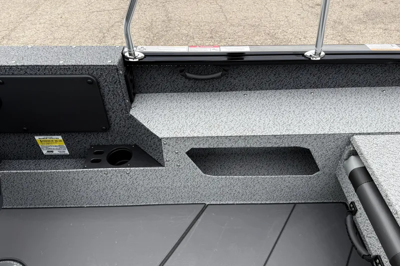 Slide: The Image of Interior view of 2026 Lund 1775 Impact XS Sport boat, featuring storage compartments. - 23