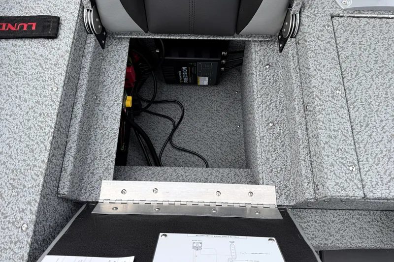 Slide: The Image of 2026 Lund 1775 Impact XS Sport boat interior storage compartment with wiring and equipment. - 27