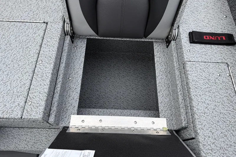 Slide: The Image of 2026 Lund 1775 Impact XS Sport boat interior with storage compartment and seat detail. - 28