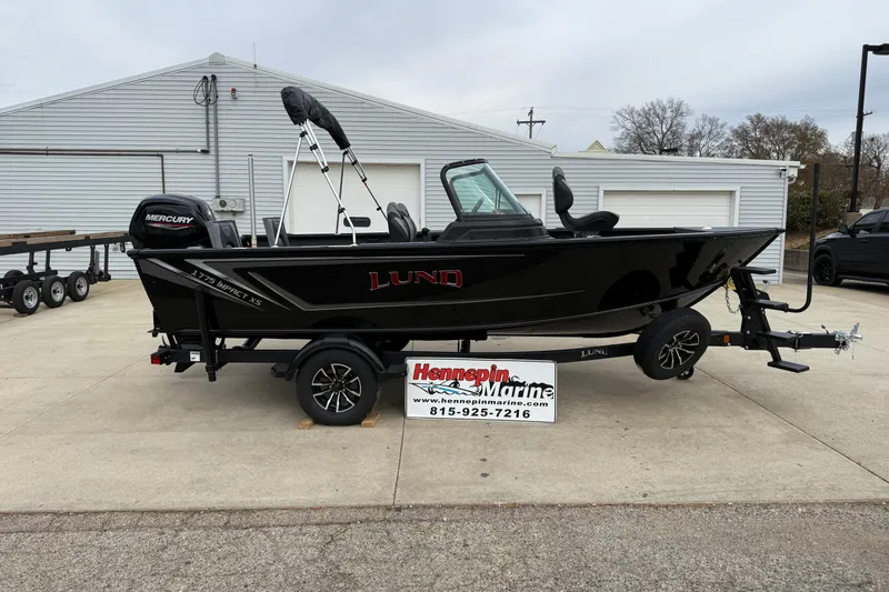 Slide: The Image of 2026 Lund 1775 Impact XS Sport boat on trailer, displayed at Hennepin Marine dealership. - 7