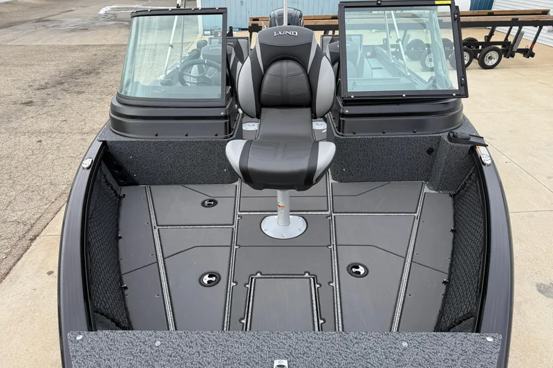 Slide: The Image of 2026 Lund 1775 Impact XS Sport boat interior with seating and windshield. - 8