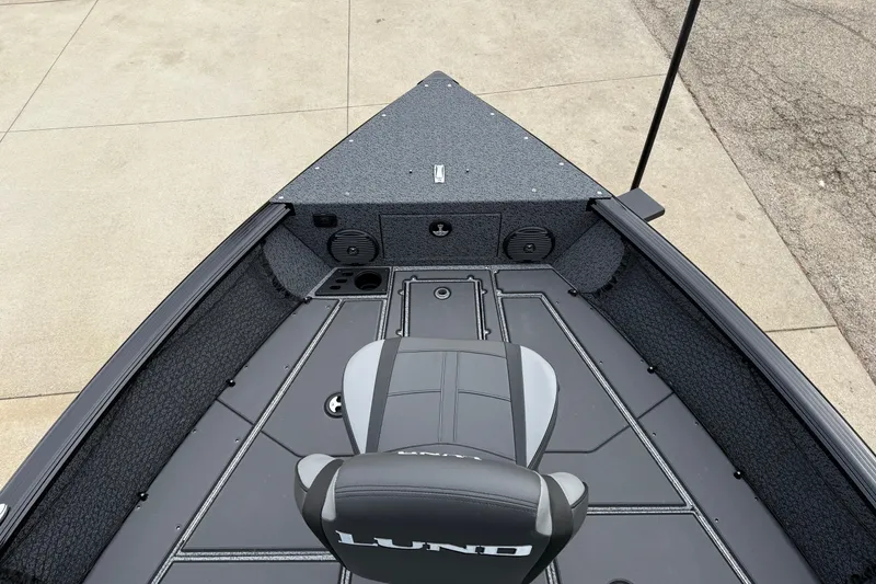 Slide: The Image of 2026 Lund 1775 Impact XS Sport boat interior with gray seating and deck. - 9