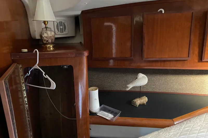 Slide: The Image of Interior of 1988 Luhrs Tournament 320 Convertible with wooden cabinets and decorative items. - 12