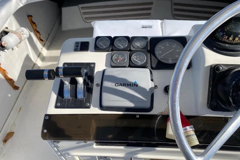 Slide: The Image of Control panel of a 1988 Luhrs Tournament 320 Convertible boat with Garmin navigation. - 16