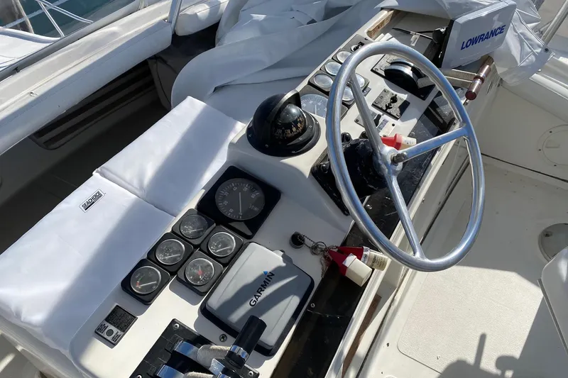 Slide: The Image of 1988 Luhrs Tournament 320 Convertible helm with steering wheel, gauges, and navigation equipment. - 19