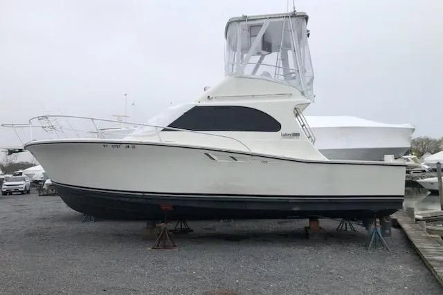Slide: The Image of 1988 Luhrs Tournament 320 Convertible boat on stands, side view. - 5