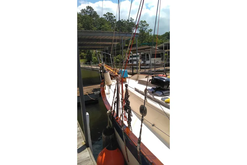 Slide: The Image of 1977 Westsail 32 sailboat docked, featuring rigging and deck details. - 2