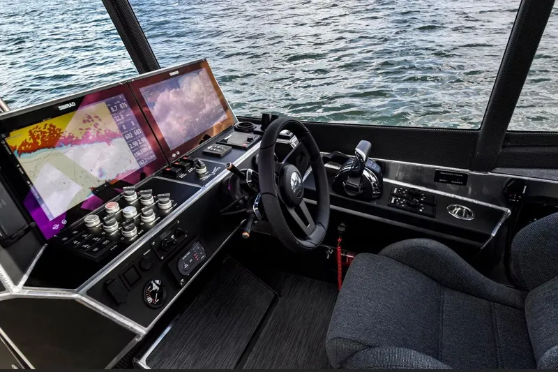 Slide: The Image of Modern boat cockpit with dual navigation screens, steering wheel, and controls, Viggo C10 2024 model. - 10