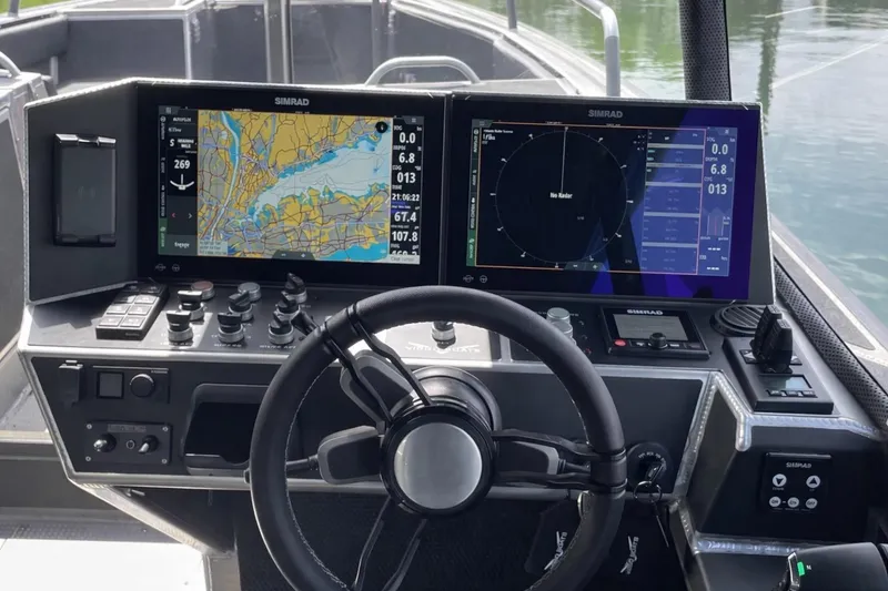 Slide: The Image of Steering console of 2024 Viggo C10 boat with dual Simrad navigation displays. - 13