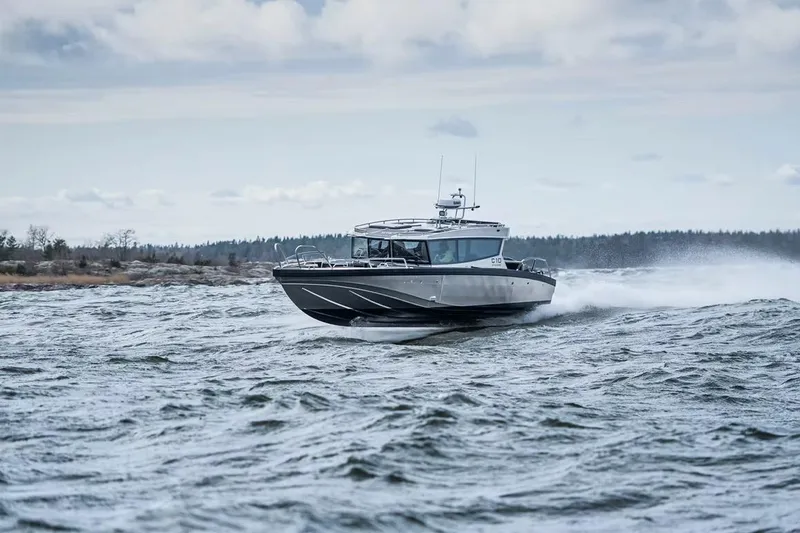 Slide: The Image of 2024 Viggo C10 boat cruising on choppy waters under a cloudy sky. - 21