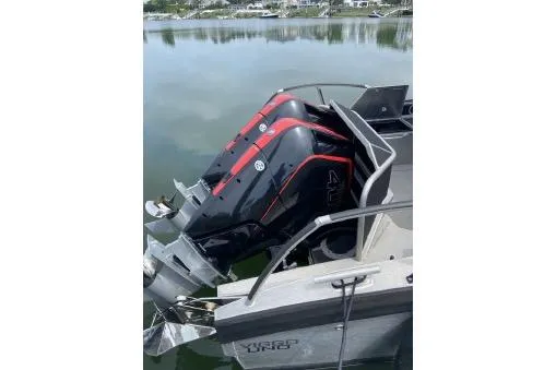 Slide: The Image of 2021 Viggo C10 boat with dual outboard motors on a calm lake. - 23