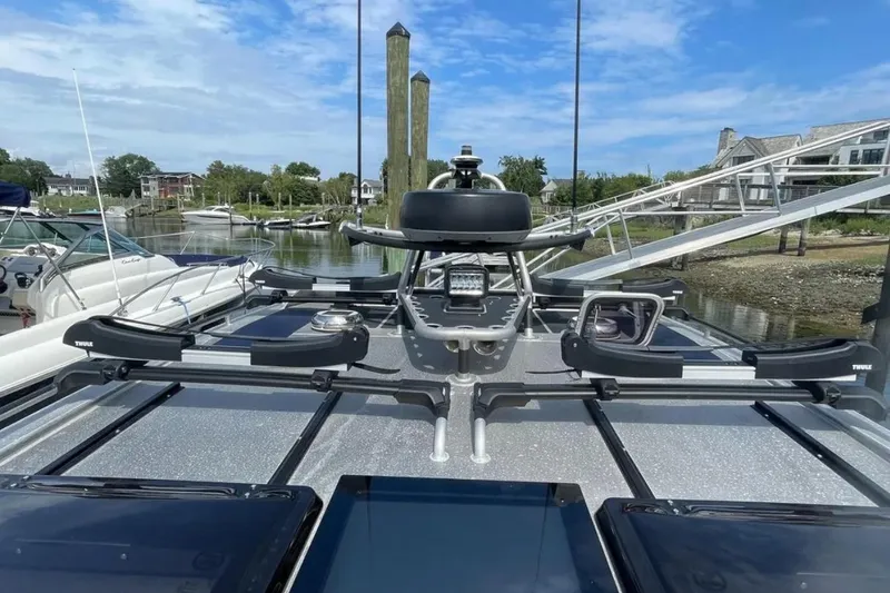 Slide: The Image of 2021 Viggo C10 boat with Thule racks, docked in a scenic marina setting. - 5