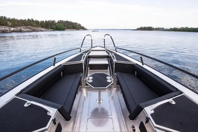 Slide: The Image of 2024 Viggo C10 boat interior with sleek seating, table, and scenic water view. - 7