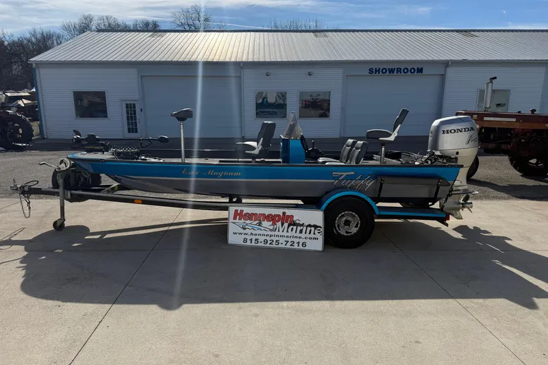 The Image of 1997 Tuffy 1700 ESOX MAGNUM fishing boat on trailer outside showroom. - 1