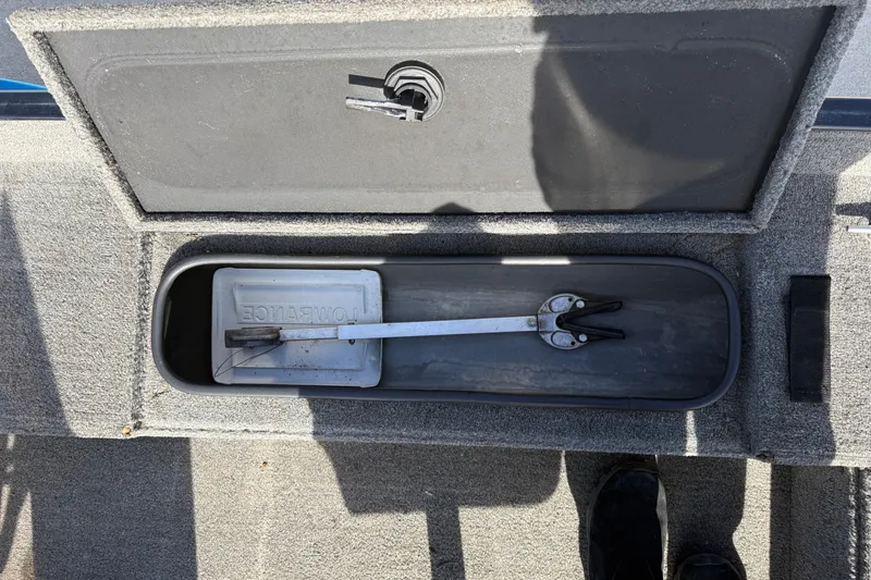 Slide: The Image of 1997 Tuffy 1700 ESOX MAGNUM boat storage compartment with tool and Lowrance cover. - 13