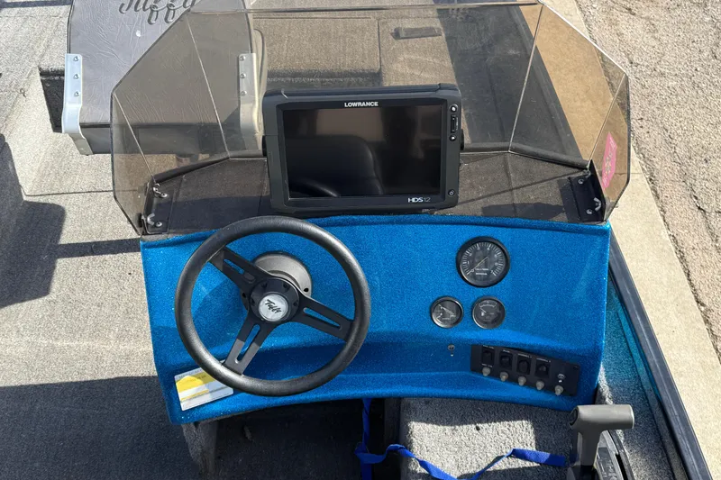 Slide: The Image of 1997 Tuffy 1700 ESOX MAGNUM boat dashboard with steering wheel and Lowrance HDS-12 display. - 15