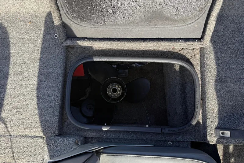 Slide: The Image of Open storage compartment in a 1997 Tuffy 1700 ESOX MAGNUM boat, revealing a propeller. - 17