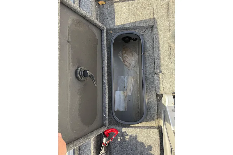 Slide: The Image of Open storage compartment in 1997 Tuffy 1700 ESOX MAGNUM boat, showing interior details. - 18