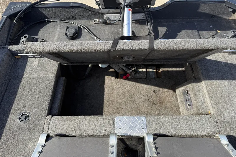 Slide: The Image of 1997 Tuffy 1700 ESOX MAGNUM boat interior with open storage compartment and visible wiring. - 19