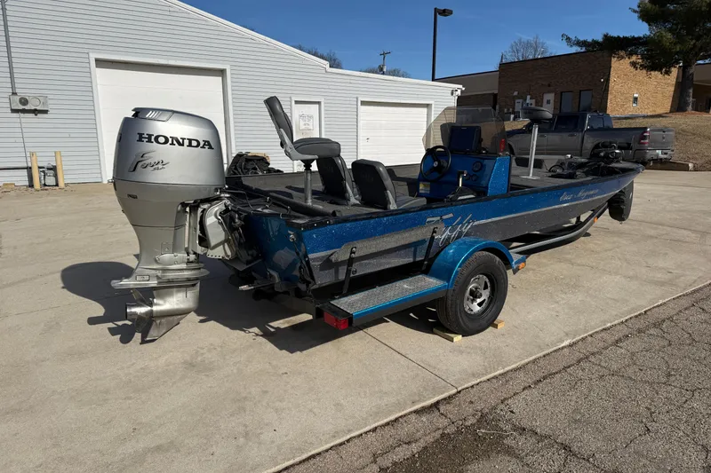 Slide: The Image of 1997 Tuffy 1700 ESOX MAGNUM boat with Honda outboard motor on trailer. - 4