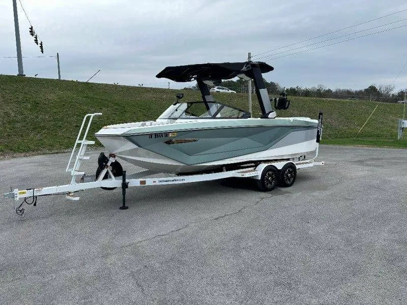The Image of 2022 Nautique G23 boat on trailer, side view. - 1