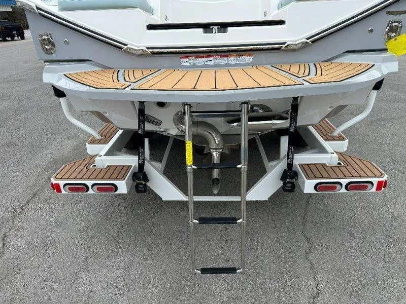 Slide: The Image of Rear view of 2022 Nautique G23 with swim platform and ladder. - 12