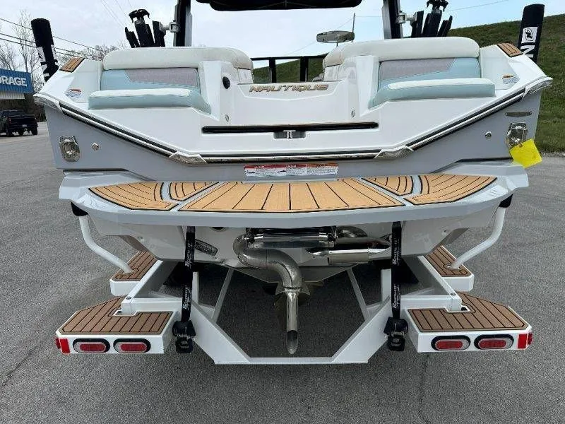 Slide: The Image of Rear view of a 2022 Nautique G23 boat with wooden deck. - 13