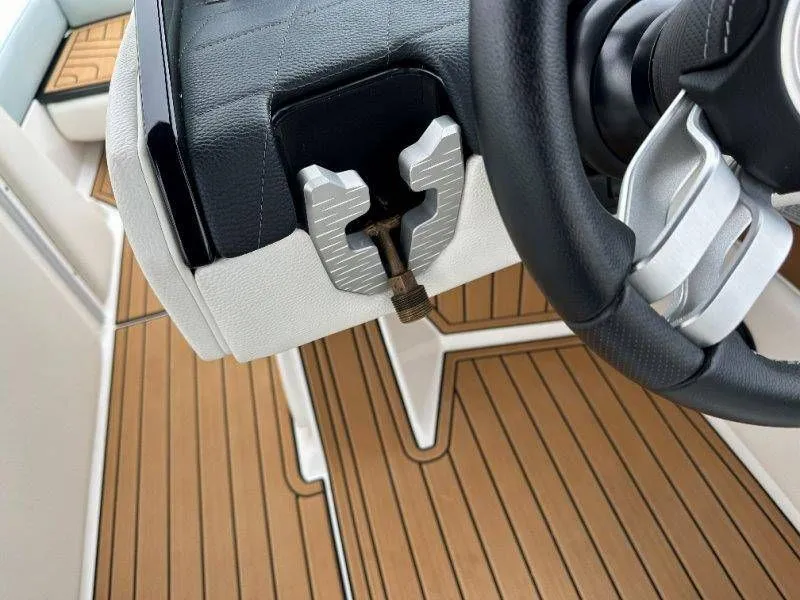 Slide: The Image of Steering wheel and dashboard of a 2022 Nautique G23 boat. - 15