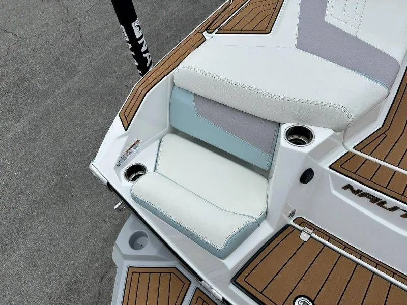 Slide: The Image of 2022 Nautique G23 boat seat with wood finish and cup holder. - 25