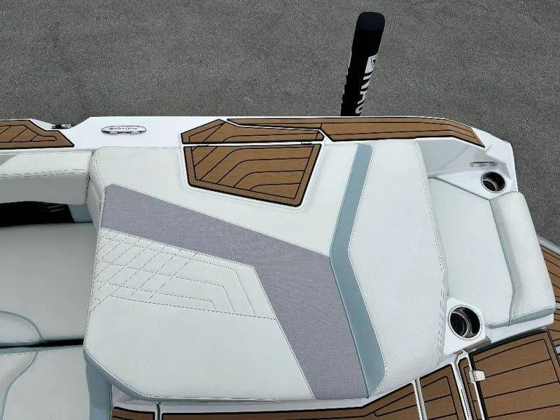 Slide: The Image of 2022 Nautique G23 boat seat with wood and leather accents. - 28