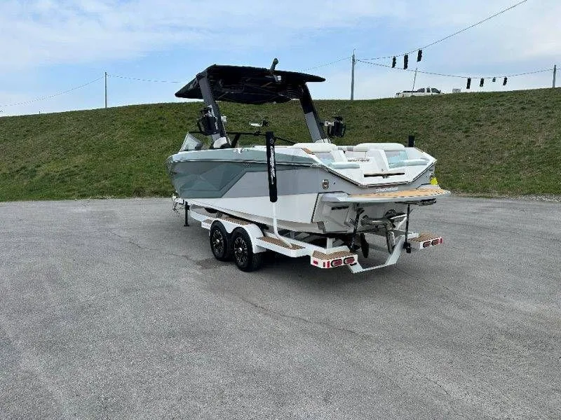 Slide: The Image of 2022 Nautique G23 boat on trailer, side view. - 3