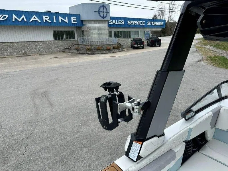 Slide: The Image of 2022 Nautique G23 boat in front of a marine store. - 32
