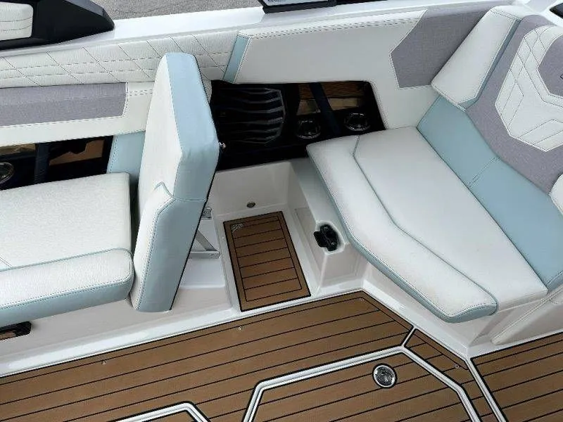 Slide: The Image of Interior of 2022 Nautique G23 with luxurious seating and wood flooring. - 34