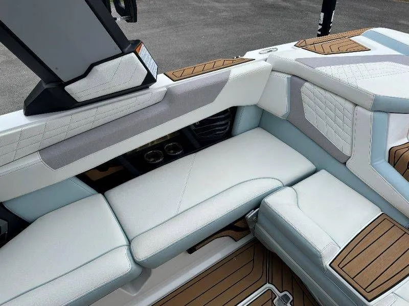 Slide: The Image of Interior of 2022 Nautique G23 with luxurious seating and wood accents. - 36