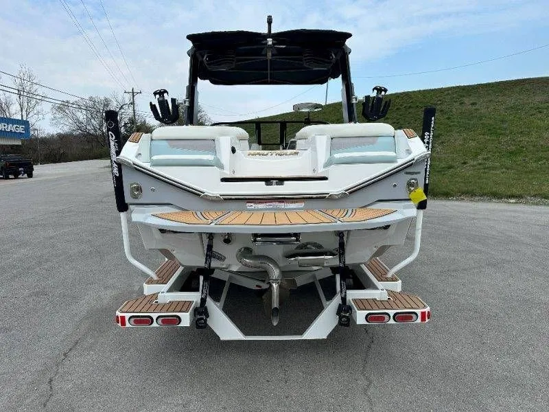 Slide: The Image of Rear view of a 2022 Nautique G23 boat on asphalt. - 4