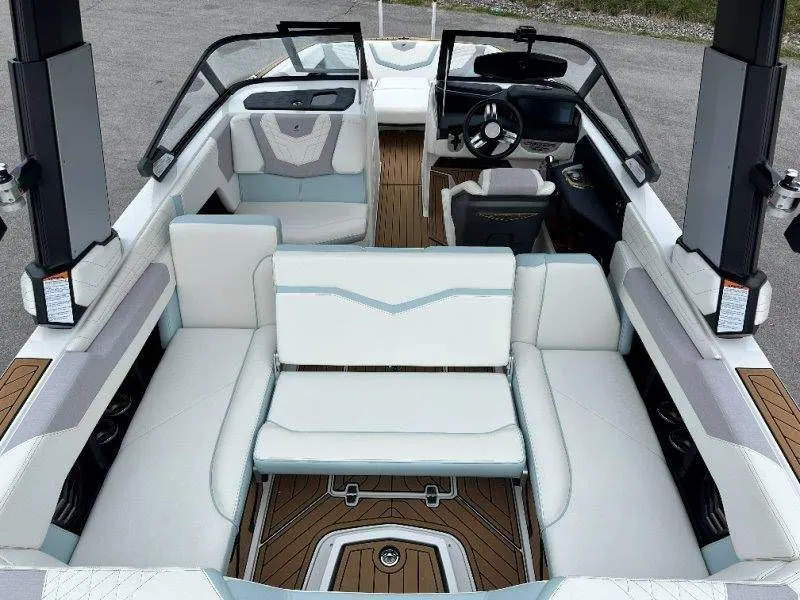 Slide: The Image of Interior of a 2022 Nautique G23 boat with luxurious white upholstery. - 42