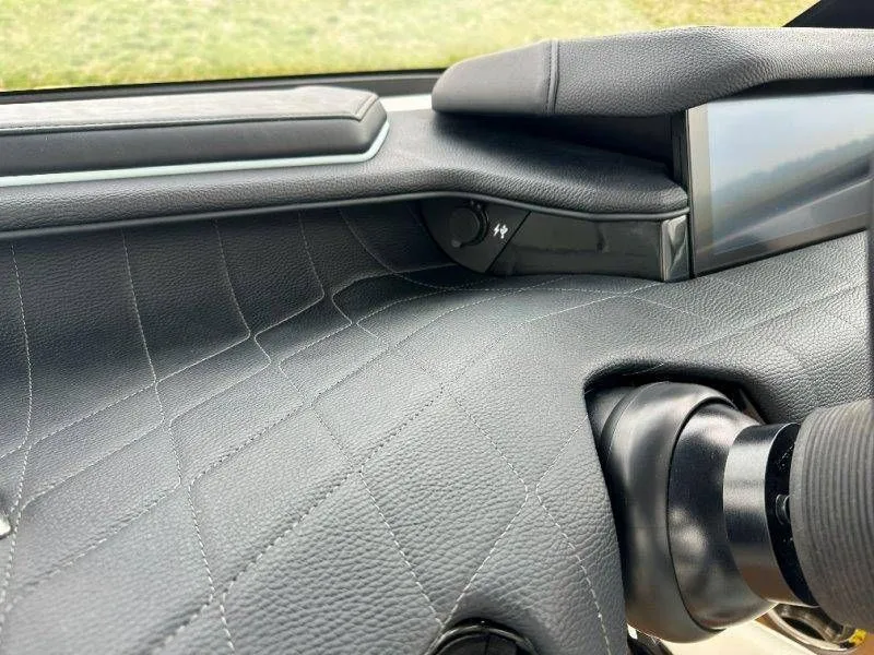 Slide: The Image of Interior view of 2022 Nautique G23 with leather dashboard. - 44