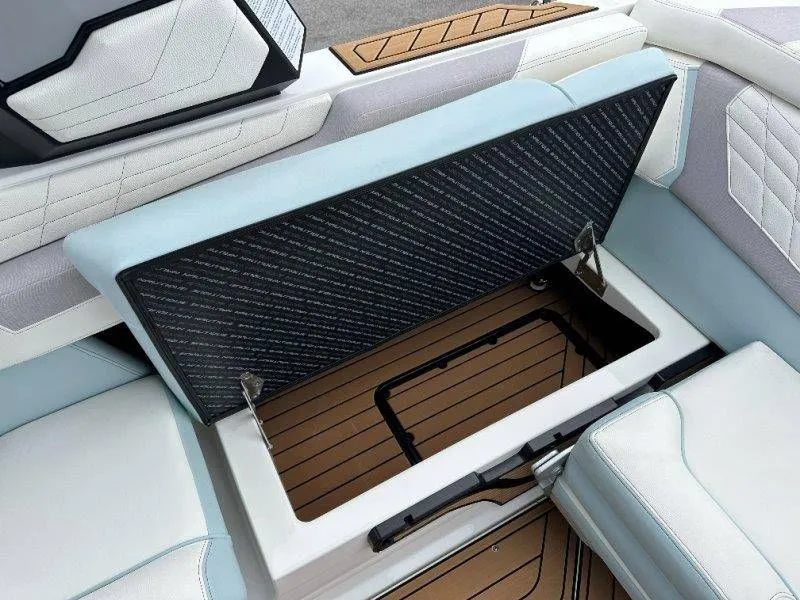 Slide: The Image of Nautique G23 2022 boat with open storage compartment and luxurious upholstery. - 49