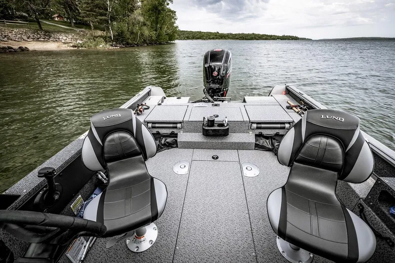 Slide: The Image of Manufacturer Provided Image: 2025 Lund 1775 Impact XS Sport boat interior on a serene lake. - 7