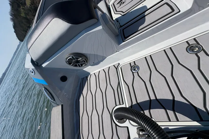 Slide: The Image of 2024 Sunsation 32 CCX boat interior with sleek deck design and speaker detail. - 13