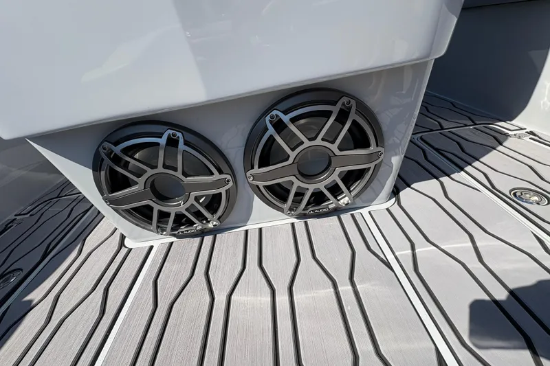 Slide: The Image of 2024 Sunsation 32 CCX boat speakers on sleek, striped deck. - 14