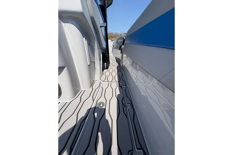 Slide: The Image of 2024 Sunsation 32 CCX boat deck with sleek, modern design and blue accents. - 18