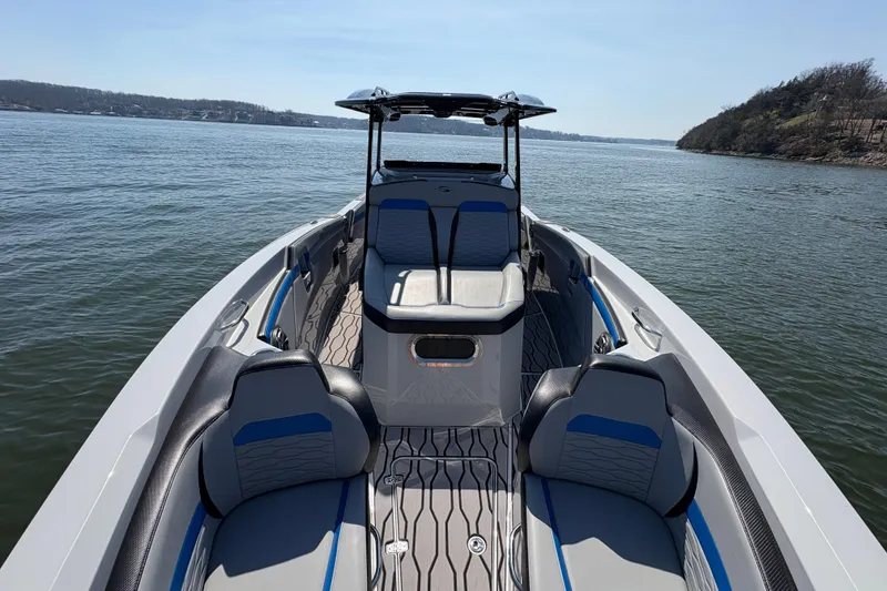 Slide: The Image of 2024 Sunsation 32 CCX boat interior with sleek seating on a calm lake. - 24