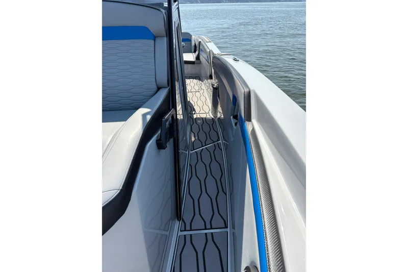 Slide: The Image of 2024 Sunsation 32 CCX boat interior with sleek seating and modern design on the water. - 26