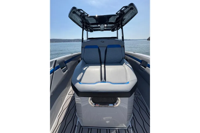 Slide: The Image of 2024 Sunsation 32 CCX boat interior with cushioned seating and open water view. - 27